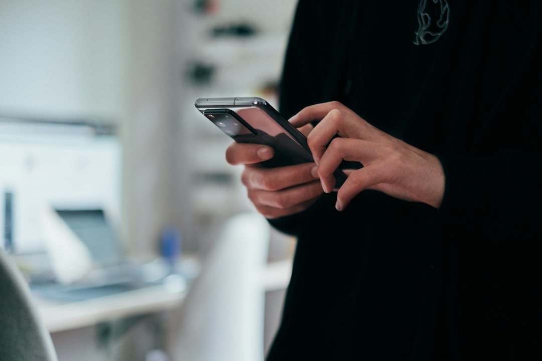 Text slang - Person holding black android smartphone